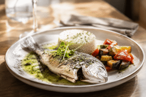Daurade Royal entière avec un sauce vierge servi avec du riz et une ratatouille à la Provençal